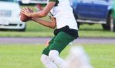 Leone Lions quarterback, Oakland Salave’a locking on to a receiver for a long pass from midfield, during the opening quarter of their JV match up against the Warriors last Thursday evening, where Salave’a led the Lions to their third victory of the season, a 16-6 win. [photo: TG]