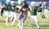 Ben Tuimaseve of Tafuna is stopped immediately by a host of Lions behind the line of scrimmage during the opening quarter of their varsity match last Friday evening, where Tafuna was handed their second loss of the season, 26-44. [photo: TG]