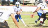 Jr. Tanielu of the Sharks scrambling with the ball after not finding an open receiver - one of the most vulnerable times for any defensive unit. Tanielu is one of the most dangerous running quarterbacks in the ASHSAA league. [photo: TG]