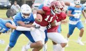 Tafuna Warriors ball carrier trying to escape Samoana’s defenders