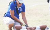 ASHSAA ATC Florence Wasko tends to an injured Nu’uuli Wildcat on the field during a Junior Varsity game against the Tafuna Warriors last Friday evening.  [photo: TG]