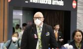 Travellers wearing face masks exit the arrivals hall at Auckland International Airport