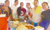Array of yummy food with young ladies serving
