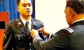 PV2 Nikolao II Chacko Mutini having his wings pinned on by his brother John.