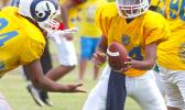 Rams quarterback Taiese Saofaigaalii is about to send Miraculous Naiuli up the middle with the hand off during the second quarter of an AYFS semi-final match last Saturday. [photo: TG]