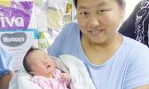 Mrs. Mrs Zhang Chao Jun and her New Year baby