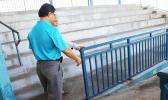 Parks & Rec director Maeatanoa Pili Gaoteote and a staff member checking out the loose metal railing at the baseball field that parents were complaining about being a hazard to kids who utilize the field for sporting events, most recently, the summer baseball clinics. See story for full details. [photo: THA]