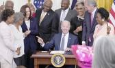 President Joe Biden points to Opal Lee after signing the Juneteenth National Independence Day Act, in the East Room of the White House, Thursday, June 17, 2021, in Washington. From left, Rep. Barbara Lee, D-Calif, Rep. Danny Davis, D-Ill., Opal Lee, Sen. Tina Smith, D-Minn., Vice President Kamala Harris, House Majority Whip James Clyburn of S.C., Sen. Raphael Warnock, D-Ga., Sen. John Cornyn, R-Texas, obscured, Rep. Joyce Beatty, D-Ohio, Sen. Ed Markey, D-Mass., and Rep. Sheila Jackson Lee, D-Texas. (AP Photo/Evan Vucci) President Joe Biden points to Opal Lee after signing the Juneteenth National Independence Day Act