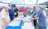 Veterns cutting the cake at a Pre-Veterans Day block party