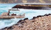A boat in rough surf at Aunuu