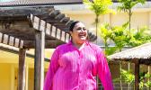 Aigalesala Toelupe in pink wearing her creation