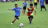 A Black Roses player (left) and Lion Heart opponent battle for possession 