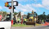 Heavy equipment removing bus stop in front of Laufou