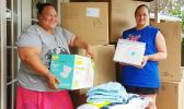 Malia Lameta and Joyce Purcell with boxes of donations