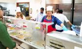Amata serving food to the troops in Kuwait over the Christmas holiday