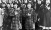 In this April 1942 file photo made available by the Library of Congress, children at the Weill public school in San Francisco recite the Pledge of Allegiance. Some of them are evacuees of Japanese ancestry who will be housed in War Relocation Authority centers for the duration of World War II. (Dorothea Lange/U.S. War Relocation Authority via AP, File) children at the Weill public school in San Francisco recite the Pledge of Allegiance. Some of them are evacuees of Japanese ancestry who will be housed in War Relocation Authority centers for the duration of World War II.