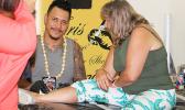 Christopher Adolfo Krieg smiles for the Samoa News Camera while tattooing a tourist