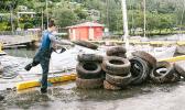 Stacking up tires cleaned up from the bottom of Malaloa Marina