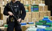 An officer stand guard over a fraction of the cocaine seized from a ship at a Philadelphia port that was displayed at a news conference at the U.S. Custom House in Philadelphia, Friday, June 21, 2019. Federal officials have estimated the seized drugs had a street value of more than $1 billion. (AP Photo/Matt Rourke) An officer stand guard over a fraction of the cocaine seized