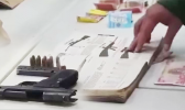 Iraqi money, illegal guns and ammunition, as well as a hardcover book with descriptions of various guns