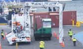 Two vehicles going through the large container scanner at the main port yesterday morning as part of the training for Customs agents, who will be manning the scanner once the service is implemented by Customs.  [photo: FS]