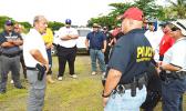 Ernie Haleck (middle) - the lead instructor in Firearms and Tactics for the National Tactical Officers Association (NTOA) and DPS in American Samoa - briefing local police officers last week, on the last day of a 2-week training course that certifies them to carry weapons. See story for details.  [photo: AF]