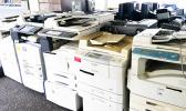 Some of the copy machines being auctioned off this week at the Office of Property Management. Items like used office equipment, kitchen appliances, jet skis and vehicles are being sold for pennies on the dollar during the auction.  [photo: Blue Chen-Fruean]
