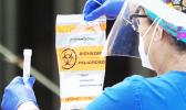 Healthcare worker with COVID-19 test kit
