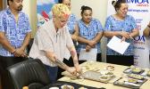 Samoa Airways staff members seeing samples of the airline’s new “farm to plane” menu
