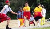 Teammates running after one of the women hit the ball 
