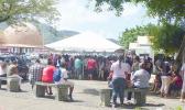 A crowd gathered at Social Service office under the tents with no social distancing