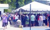 People crowded under the tents at Social Services in Utulei on Monday, April 20 for apparently Gita relief money.