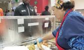 Congresswoman Aumua Amata dishing up food for troops