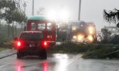 Emergency crews rushed to the scene a large downws tree in Fagaalu around 7a.m. Friday to clear the road as well as move an aiga bus, which was hit on the front section when the tree fell in the midst of strong gust winds from Tropical Storm Gati. No one was injured.  [photo: Fili Sagapolutele]