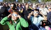 A crowd wears protective glasses as they watch the beginning of the solar eclipse from Salem, Ore., Monday, Aug. 21, 2017. (AP Photo/Don Ryan) A crowd wears protective glasses as they watch the beginning of the solar eclipse from Salem, Ore., Monday, Aug. 21, 2017. (AP Photo/Don Ryan)
