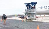 Passengers board a United Airlines flight in Majuro. For the first time in late January, Marshall Islands Immigration officials detained several passengers at Majuro's international airport for questioning in relation to participation in illegal adoptions in the United States. [Photo: Giff Johnson]