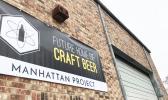 Photo of The Manhattan Project Beer Company building and sign