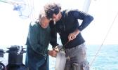  Captain Charles Moore (left) and a crew member collect plastic from the South Pacific gyre. [Photo: Supplied/ Algalita Marine Research]