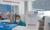 A woman working at Bluesky wearing a surgical face mask