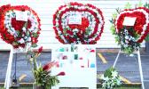 Flowers with photographs in place at the site where three Manu'a Store employees died