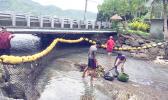 Aua Village was the first to complete the challenge "installation of marine debris encatchment net" on island, which was set up by American Samoa Power Authority and the village council. The net was set up at the stream on the main road of Aua. Aua 1st Ward of LDS faith adopted the stream and was very happy to have the net to help keep their coast clean and healthy. [photo: Ese Malala]