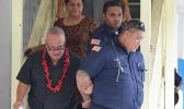 Deputy Commissioner Falana’ipupu Ta’ase Sagapolupele (left) and two other police officers escorting Police Officer Fa’auma Malo (right) after his arrest in 2017