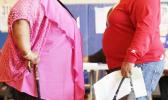 In this June 26, 2012, file photo, two women converse in New York. "Socially accepted normal body weight is shifting toward heavier weight. As more people around us are getting heavier, we simply believe we are fine, and no need to do anything with it," said Dr. Jian Zhang, a public health researcher at Georgia Southern University and the lead author in a study released on Tuesday, March 7, 2017. (AP Photo/Mark Lennihan, File) In this June 26, 2012, file photo, two women converse in New York. "Socially accepted normal body weight is shifting toward heavier weight. As more people around us are getting heavier, we simply believe we are fine, and no need to do anything with it," said Dr. Jian Zhang, a public health researcher at Georgia Southern University and the lead author in a study released on Tuesday, March 7, 2017. (AP Photo/Mark Lennihan, File)