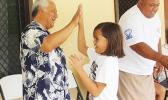 FFAS president, Sen. Faiivae Iuli Alex Godinet, high fives a player on
