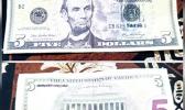 Photos of back and front of fake $5 bill.