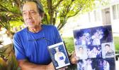 In this Monday, July 10, 2017 photo, Clifford Kang, father of soldier Ikaika E. Kang, poses with photo of his son in Kailua, Hawaii. Ikaika E. Kang, an active-duty U.S. soldier, was arrested over the weekend on terrorism charges that accuse him of pledging allegiance to the Islamic State group and saying he wanted to "kill a bunch of people." (Bruce Asato/The Star-Advertiser via AP) In this Monday, July 10, 2017 photo, Clifford Kang, father of soldier Ikaika E. Kang, poses with photo of his son in Kailua, Hawaii. Ikaika E. Kang, an active-duty U.S. soldier, was arrested over the weekend on terrorism charges that accuse him of pledging allegiance to the Islamic State group and saying he wanted to "kill a bunch of people." (Bruce Asato/The Star-Advertiser via AP)