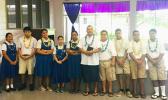 Rev. Father Kolio Etuale (middle) surrounded by students of St. Theresa Elementary School