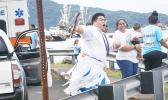 Sean Tilo and his sister Sherry cheering and dancing for their village fautasi, the Aua Paepaeulupo’o during the second heat at yesterday’s fautasi regatta for the 2017 Annual Flag Day Fautasi Faigamea i le Tai. The boat came in first in heats overall with a time of 35:19.13. The Championship Race is not set for Saturday. [Photo: EM]