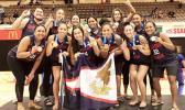 The American Samoa women’s basketball team celebrate atop the podium with their gold medals.
