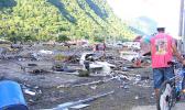 Residents at Pago Pago Park amid debris